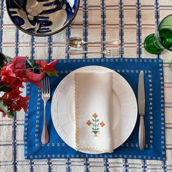 Hand-embroidered napkins in yellow linen with a pink flower