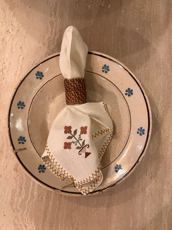 Hand-embroidered napkins in yellow linen with a pink flower